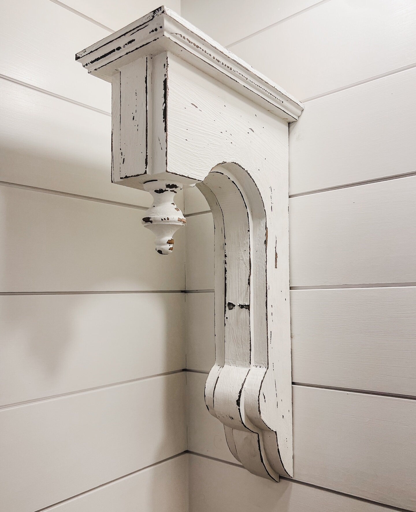 Pair of white distressed wood corbels with finial detail

Handcrafted white corbels for shelves and mantels