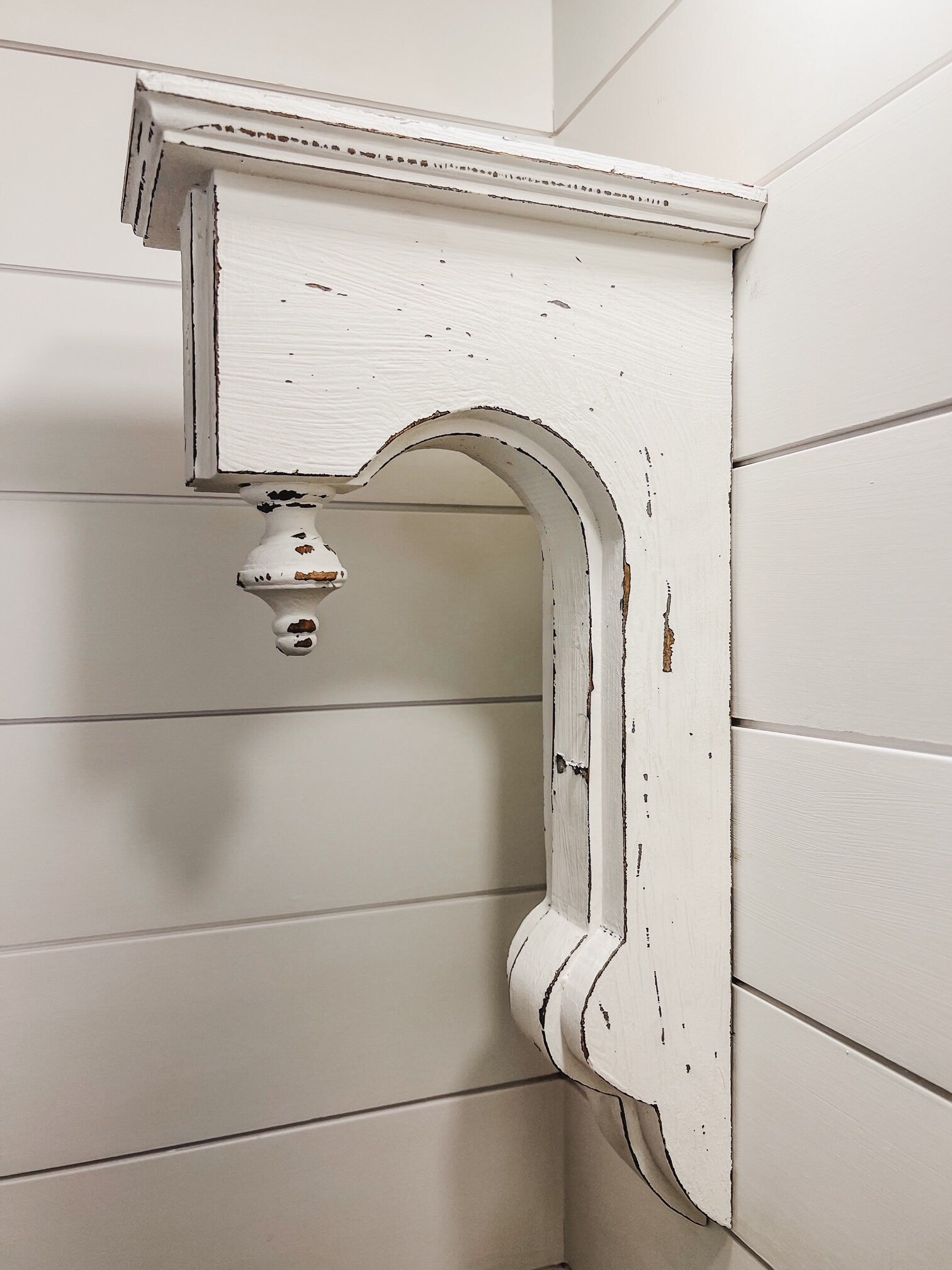 White finial corbels used as shelf brackets

Vintage inspired distressed wood corbels pair