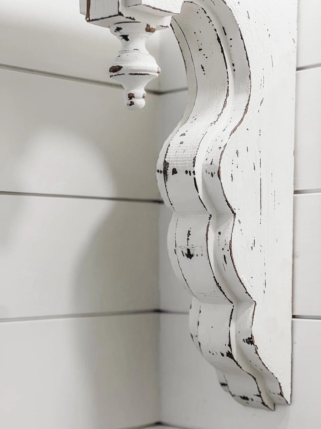 White distressed wood corbel with finial side view

Pair of white distressed corbels with finials on rustic wooden surface

Close-up of carved finial detail on white distressed corbel

17-3/8 inch tall white distressed wood corbels for mantel support