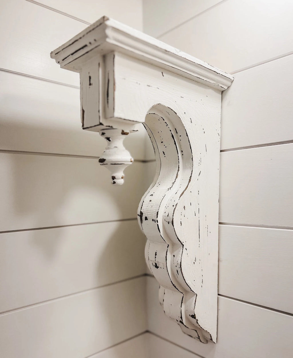 White distressed wood corbel with finial side view

Pair of white distressed corbels with finials on rustic wooden surface

Close-up of carved finial detail on white distressed corbel

17-3/8 inch tall white distressed wood corbels for mantel support