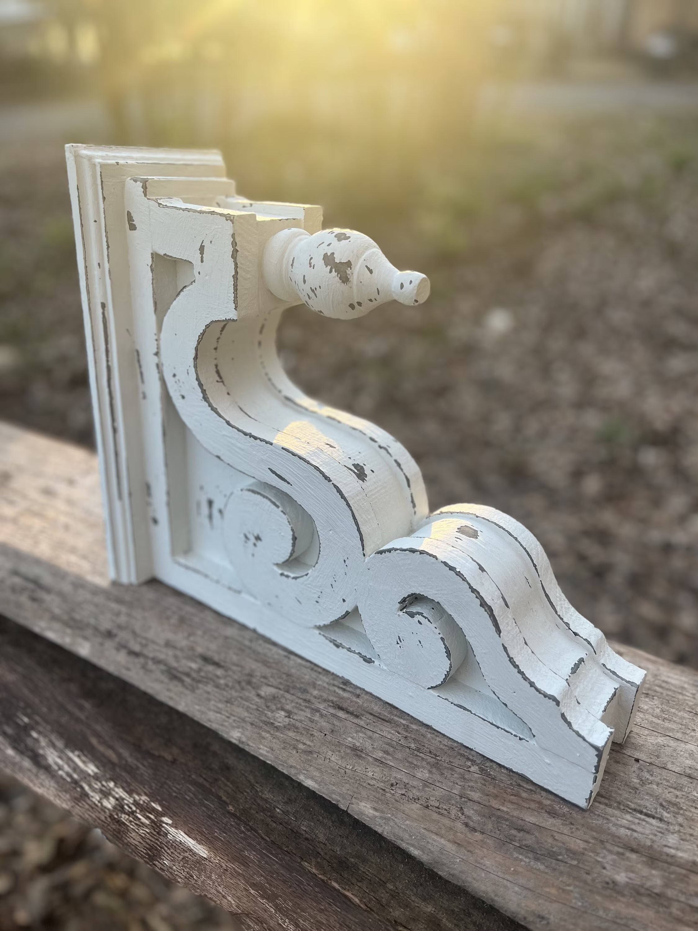 Pair of white distressed wood corbels with finial front and scroll sides

French country style rustic white corbels for mantel or shelf support

Decorative architectural wood brackets in distressed white finish