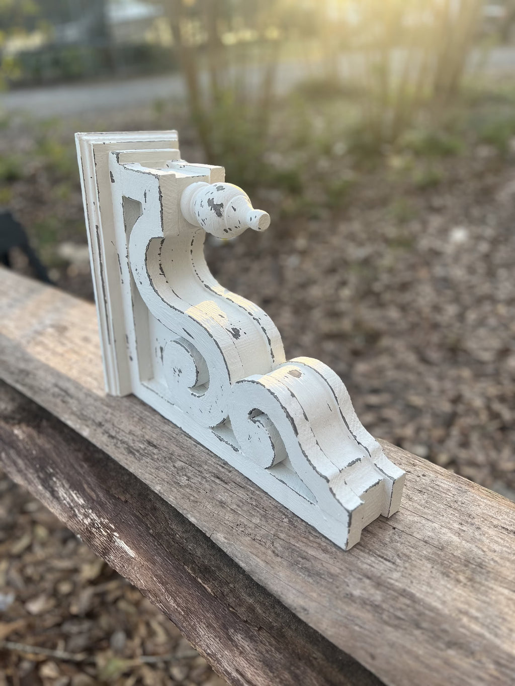 Pair of white distressed wood corbels with finial front and scroll sides

French country style rustic white corbels for mantel or shelf support

Decorative architectural wood brackets in distressed white finish