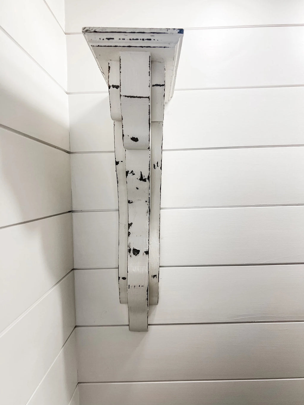 Decorative white distressed wood corbels with clean, modern lines