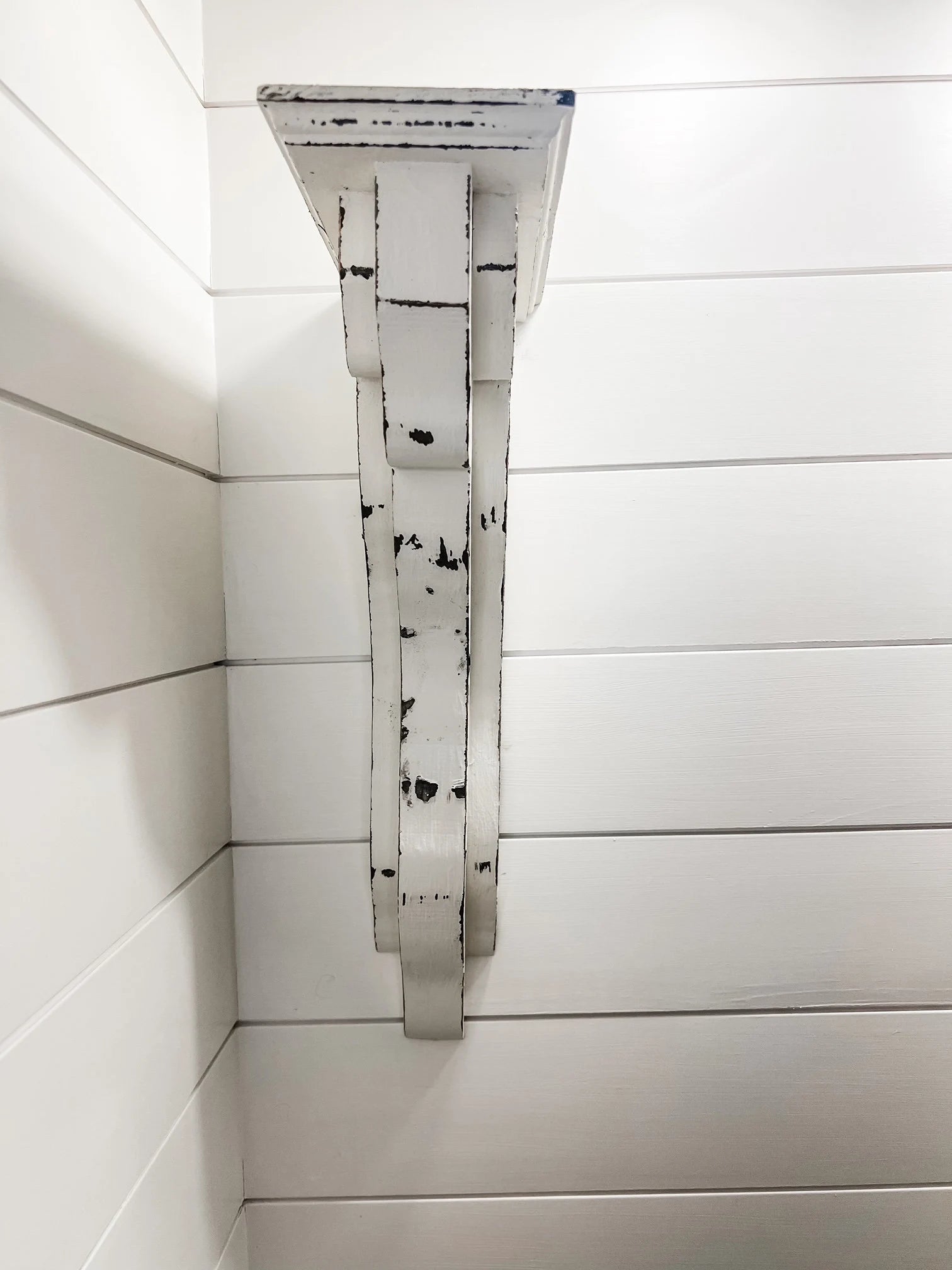 Decorative white distressed wood corbels with clean, modern lines